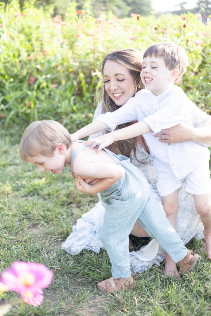 A mom plays with her two little boys during a family session by Mary Eleanor Photography.