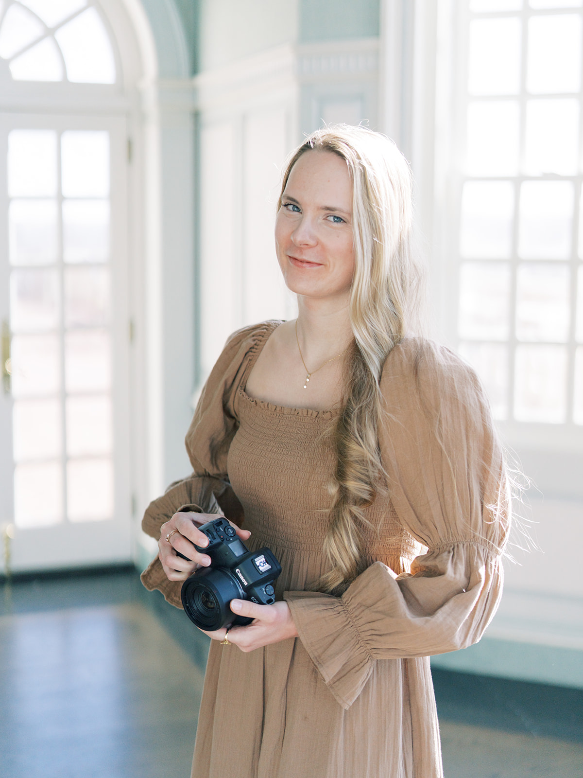 Portrait of the Photographer holding a camera.