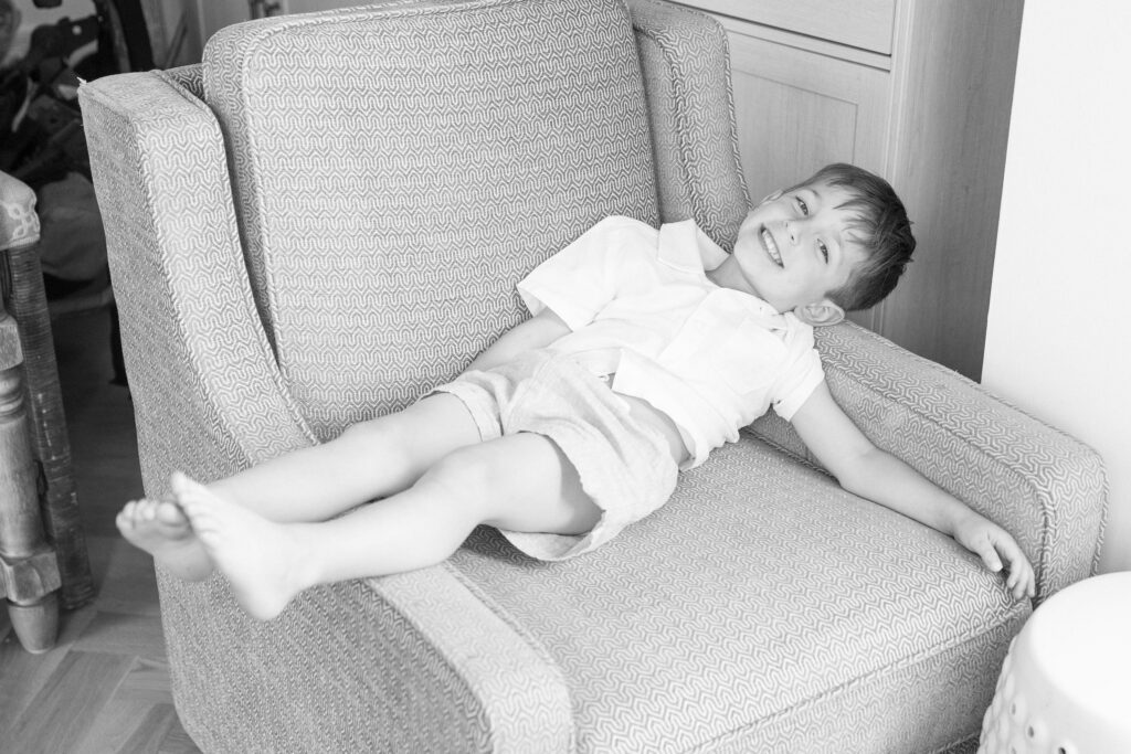 Solo photograph of toddler during at home newborn photos with siblings.
